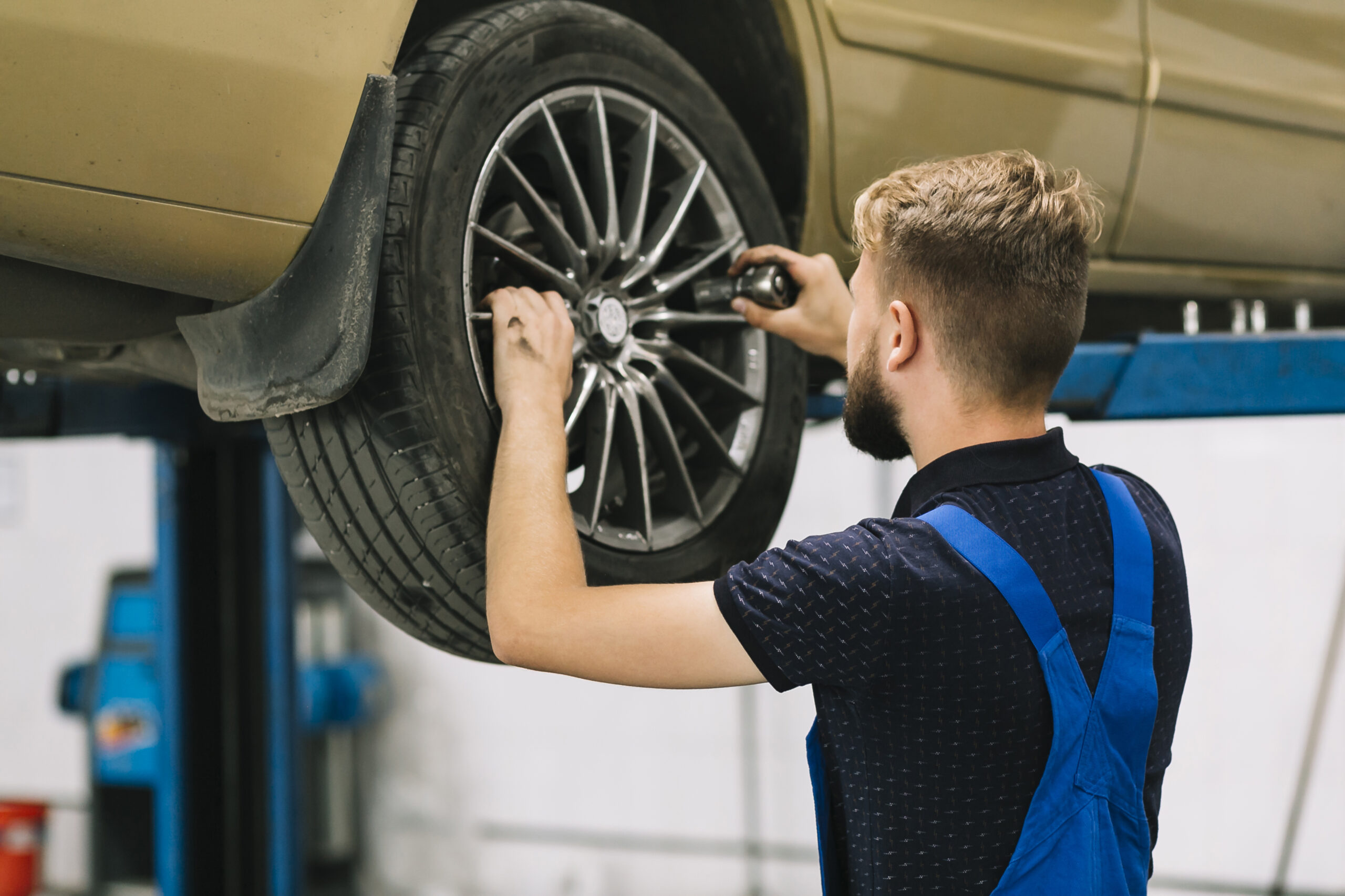 car-mechanic-trying-set-socket-auto-wheel